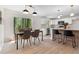 Open-concept kitchen and dining area with stainless appliances, breakfast bar, and sliding doors to the backyard at 6710 Hidden Brook Trl, Atlanta, GA 30349