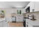 Modern kitchen with stainless steel appliances, white cabinetry, and durable countertops at 6710 Hidden Brook Trl, Atlanta, GA 30349