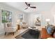Bright and airy living room with stylish furniture, modern rug, and hardwood flooring at 6710 Hidden Brook Trl, Atlanta, GA 30349