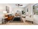 Sunlit living room with modern decor, neutral tones, wood floors, and large windows at 6710 Hidden Brook Trl, Atlanta, GA 30349