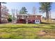 Spacious backyard featuring lush lawn, privacy fence, patio area, and classic brick exterior at 2251 Trailwood Se Dr, Smyrna, GA 30080