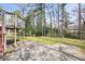 Backyard with a mix of grassy areas, mature trees, concrete patio and upper-level deck at 2251 Trailwood Se Dr, Smyrna, GA 30080