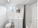 Basement bathroom features a white toilet, sink, vanity and shower with curtain at 2251 Trailwood Se Dr, Smyrna, GA 30080
