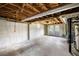 Unfinished basement featuring concrete walls and exposed ceiling, with a rear exit at 2251 Trailwood Se Dr, Smyrna, GA 30080