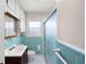 Bathroom features blue tiling, a vanity with a mirror, and a glass-door shower at 2251 Trailwood Se Dr, Smyrna, GA 30080