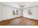 Spacious bedroom with hardwood floors, ceiling fan, and plenty of natural light from the two windows at 2251 Trailwood Se Dr, Smyrna, GA 30080
