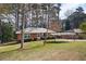 Charming single-story brick home with a well-maintained lawn and convenient carport at 2251 Trailwood Se Dr, Smyrna, GA 30080
