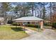 Cozy brick house with a long driveway leading to a convenient carport at 2251 Trailwood Se Dr, Smyrna, GA 30080
