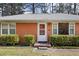 Close-up of the front door entrance, framed by trimmed bushes and a small landing at 2251 Trailwood Se Dr, Smyrna, GA 30080