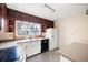 Charming kitchen with white cabinets, black dishwasher, and plenty of natural light streaming in from the window at 2251 Trailwood Se Dr, Smyrna, GA 30080