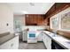 Bright kitchen with white cabinets, oven, stainless steel sink, and a window looking out onto the backyard at 2251 Trailwood Se Dr, Smyrna, GA 30080