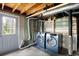Unfinished laundry room with modern washer and dryer set, exterior door, and open ceiling at 2251 Trailwood Se Dr, Smyrna, GA 30080