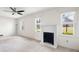 Bright living room with a ceiling fan, carpeted floors, and a decorative fireplace at 2251 Trailwood Se Dr, Smyrna, GA 30080