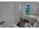 Cozy bathroom features tiled walls, vanity with sink, and a view of the lawn at 45 Hampton Dr, Cartersville, GA 30121