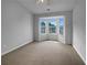 A bright bedroom features a ceiling fan and large bay windows that let in natural light at 45 Hampton Dr, Cartersville, GA 30121