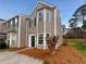 Two-story home has a neat yard and light-colored siding that brings out its many windows at 45 Hampton Dr, Cartersville, GA 30121