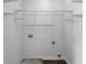A laundry room with wire shelving and hookups for a washer and dryer is ready for appliances at 45 Hampton Dr, Cartersville, GA 30121