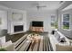 Bright living room features modern furnishings, a fireplace, and large windows offering an inviting space at 45 Hampton Dr, Cartersville, GA 30121
