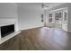 Spacious living room with a fireplace, hardwood floors, and bay windows that offer natural light at 45 Hampton Dr, Cartersville, GA 30121