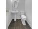 A quaint powder room provides a toilet and stylish pedestal sink to wash your hands at 45 Hampton Dr, Cartersville, GA 30121