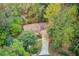An aerial view of a home with mature trees providing privacy to the house and property at 1667 Manhasset Farm Ct, Atlanta, GA 30338