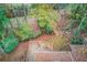 Overhead view of a wooded lot featuring a deck, home and scenic pathways at 1667 Manhasset Farm Ct, Atlanta, GA 30338