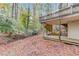 Wooded backyard with a view of the house's deck and outdoor spaces at 1667 Manhasset Farm Ct, Atlanta, GA 30338