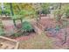 Backyard with wooded scenery and small bridge across a stream at 1667 Manhasset Farm Ct, Atlanta, GA 30338