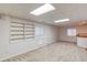 Spacious basement with neutral carpet, built-in shelves, cabinets, and bar area provides versatile living space at 1667 Manhasset Farm Ct, Atlanta, GA 30338