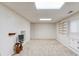 Large basement rec room featuring neutral carpet and built-in shelving and cabinets offers customizable space at 1667 Manhasset Farm Ct, Atlanta, GA 30338