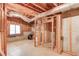 Unfinished basement featuring wooden framing, HVAC, a window, and concrete flooring and walls at 1667 Manhasset Farm Ct, Atlanta, GA 30338
