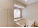Bathroom with marble tub and lots of natural light from the window at 1667 Manhasset Farm Ct, Atlanta, GA 30338