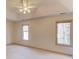 Bright bedroom with a ceiling fan and two windows showing trees outside at 1667 Manhasset Farm Ct, Atlanta, GA 30338