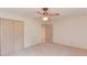 Neutral carpeted bedroom featuring a ceiling fan and ample closet space at 1667 Manhasset Farm Ct, Atlanta, GA 30338