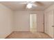 Bedroom features neutral carpet and paint and a ceiling fan with light at 1667 Manhasset Farm Ct, Atlanta, GA 30338
