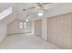 Bright and spacious carpeted room featuring a skylight and multiple closets at 1667 Manhasset Farm Ct, Atlanta, GA 30338