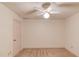 Bedroom includes neutral carpet and paint, ceiling fan with light, and a closet at 1667 Manhasset Farm Ct, Atlanta, GA 30338