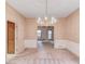 Traditional dining room features a chandelier, wainscoting and an entrance to another room at 1667 Manhasset Farm Ct, Atlanta, GA 30338