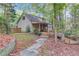 Exterior view of a home with a covered porch, wooden deck and stone pathway at 1667 Manhasset Farm Ct, Atlanta, GA 30338
