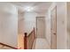Upstairs hallway with neutral walls, cream carpet, and white doors at 1667 Manhasset Farm Ct, Atlanta, GA 30338