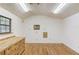 Interior of a room featuring wood floors, a window, and built-in cabinets at 1667 Manhasset Farm Ct, Atlanta, GA 30338