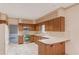 Traditional kitchen with wooden cabinets, tile floors and stainless-steel appliances at 1667 Manhasset Farm Ct, Atlanta, GA 30338