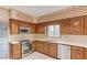 Traditional kitchen with wooden cabinets, tile floors and stainless-steel appliances at 1667 Manhasset Farm Ct, Atlanta, GA 30338