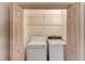 Laundry room with washer, dryer, and built-in shelving for organized convenience at 1667 Manhasset Farm Ct, Atlanta, GA 30338