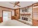 Comfortable living room with built-in shelving, stone fireplace, and ceiling fan at 1667 Manhasset Farm Ct, Atlanta, GA 30338