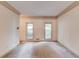 Bright living area features neutral carpet, crown molding, and natural light from two windows at 1667 Manhasset Farm Ct, Atlanta, GA 30338