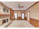 Spacious living room features a stone fireplace and custom built-in shelving at 1667 Manhasset Farm Ct, Atlanta, GA 30338