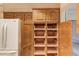 Pantry showcases clever slide out drawers next to refrigerator for smart storage at 1667 Manhasset Farm Ct, Atlanta, GA 30338