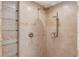 Modern shower with neutral tile, built-in shelving and dual shower heads at 1667 Manhasset Farm Ct, Atlanta, GA 30338