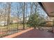 Back patio with iron railing and paver bricks overlooking the landscaped back yard at 407 North Ave, Atlanta, GA 30354